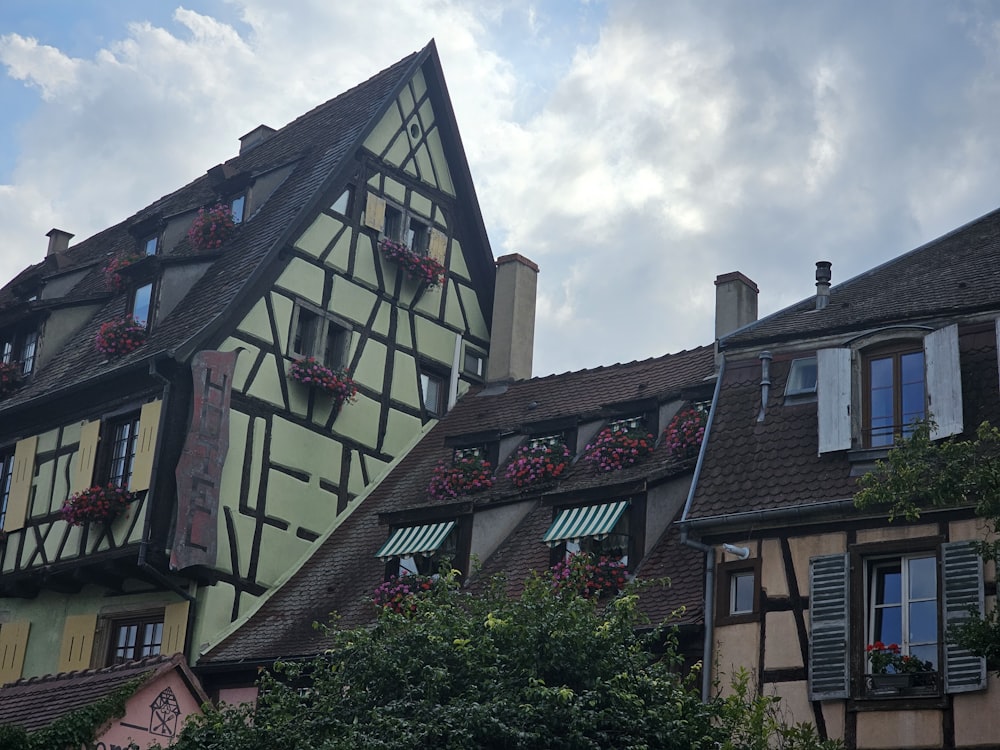 a row of houses with flower boxes on the roof