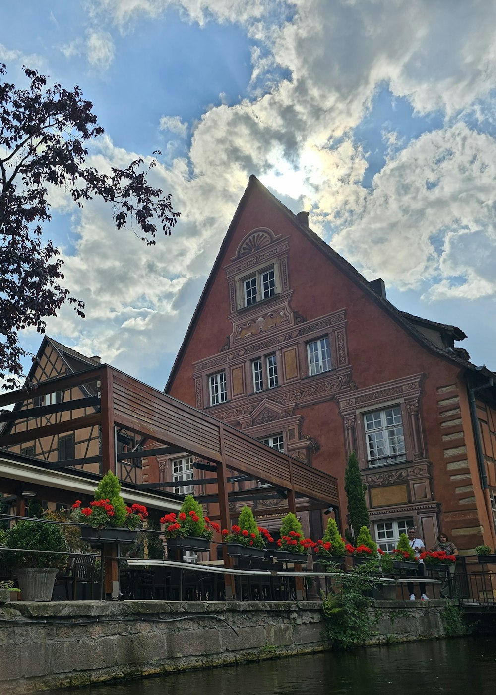 a large building with flowers growing on the outside of it