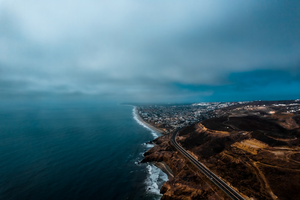 an aerial view of a highway near the ocean