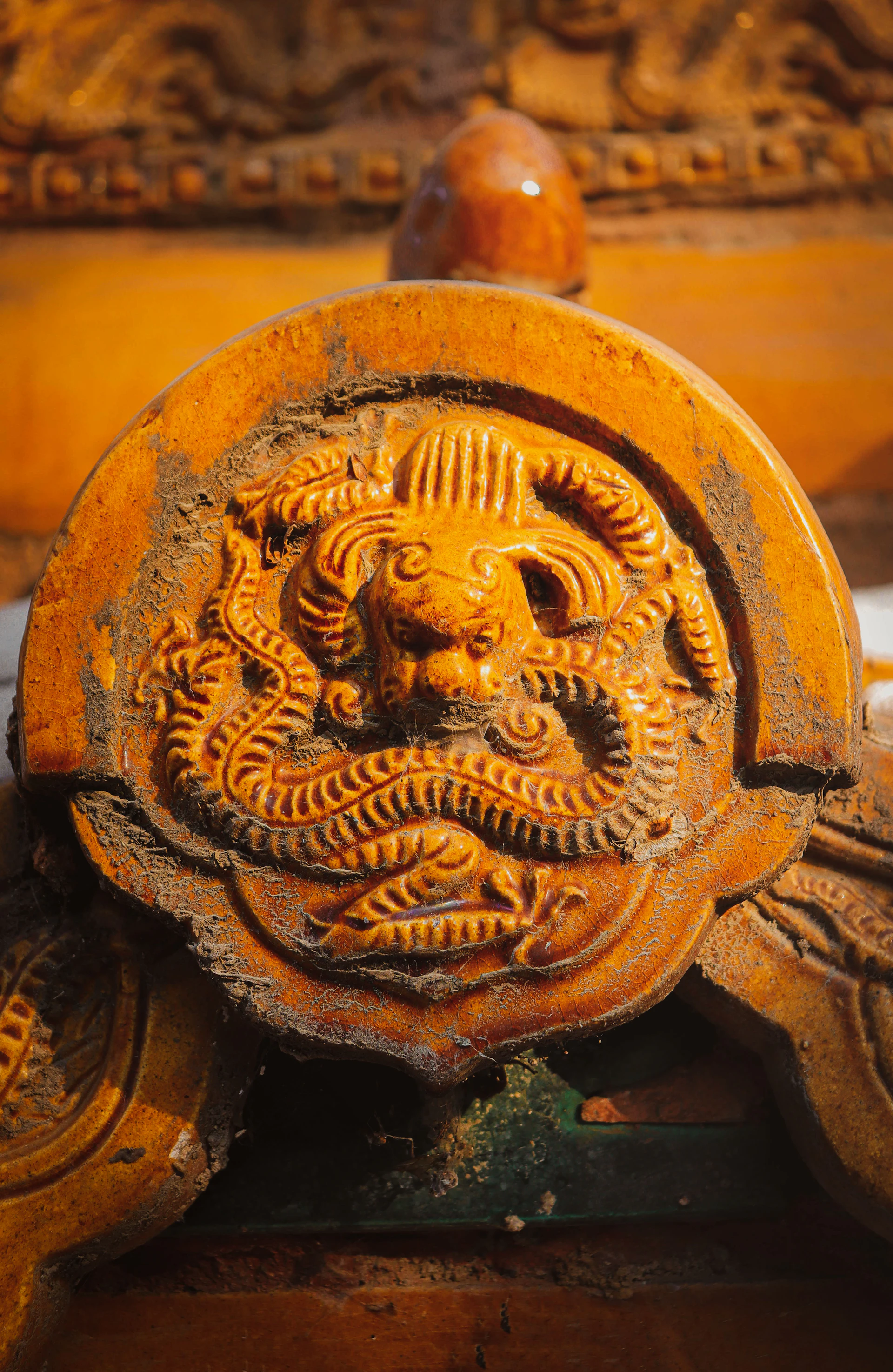 An ancient Harappan seal carved with a mysterious animal motif, resting on a smooth charcoal black surface with antique gold accents.
