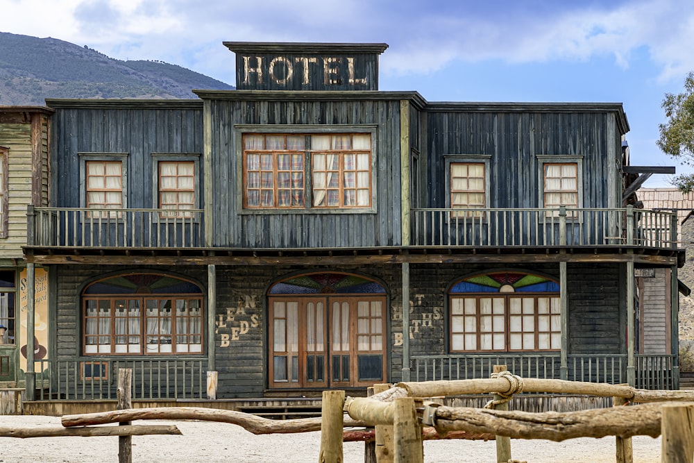 an old building with a wooden fence in front of it