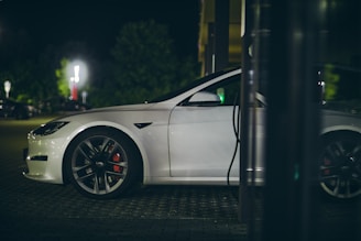 a white car parked in a parking lot at night