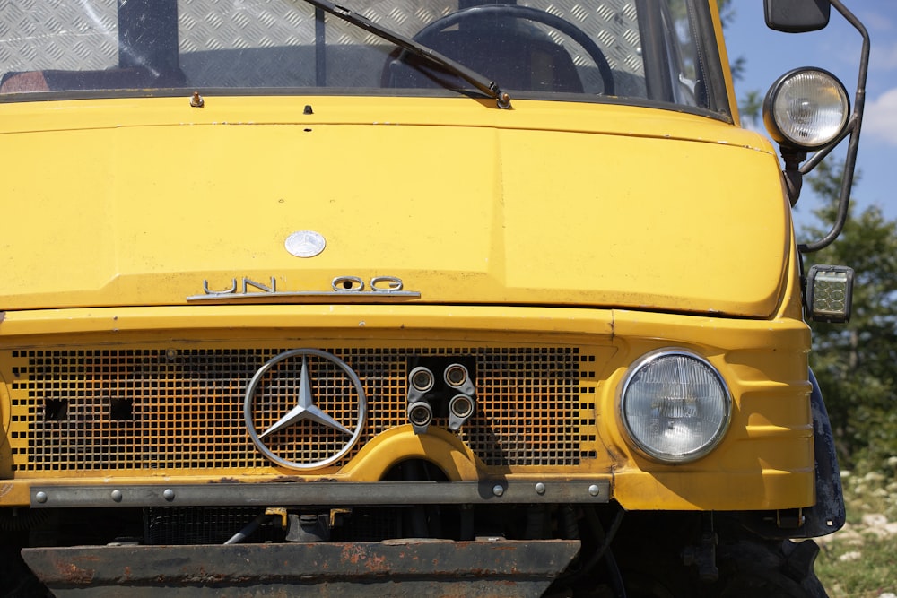 a close up of the front of a yellow truck