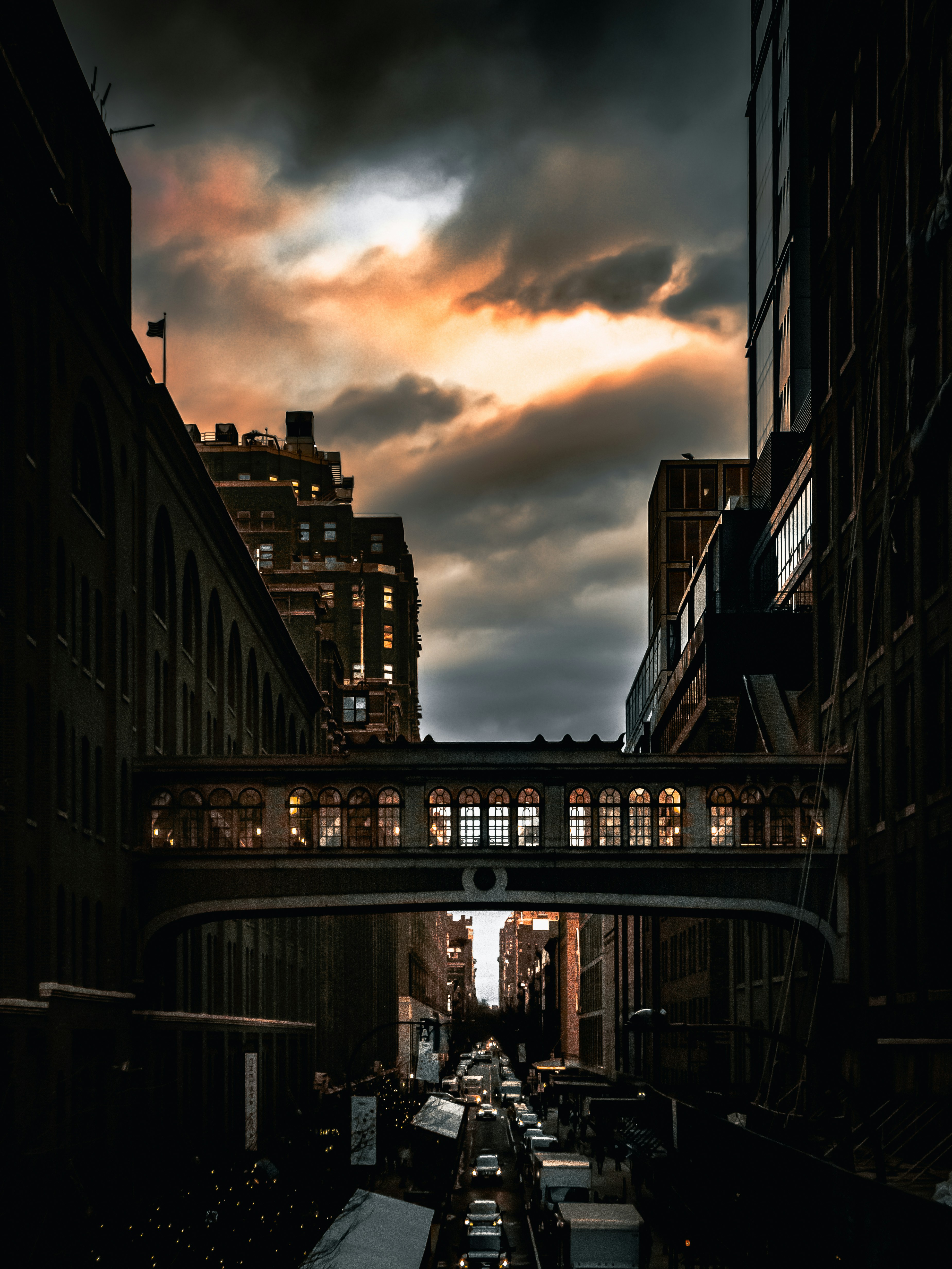 a view of a city street with a bridge over it