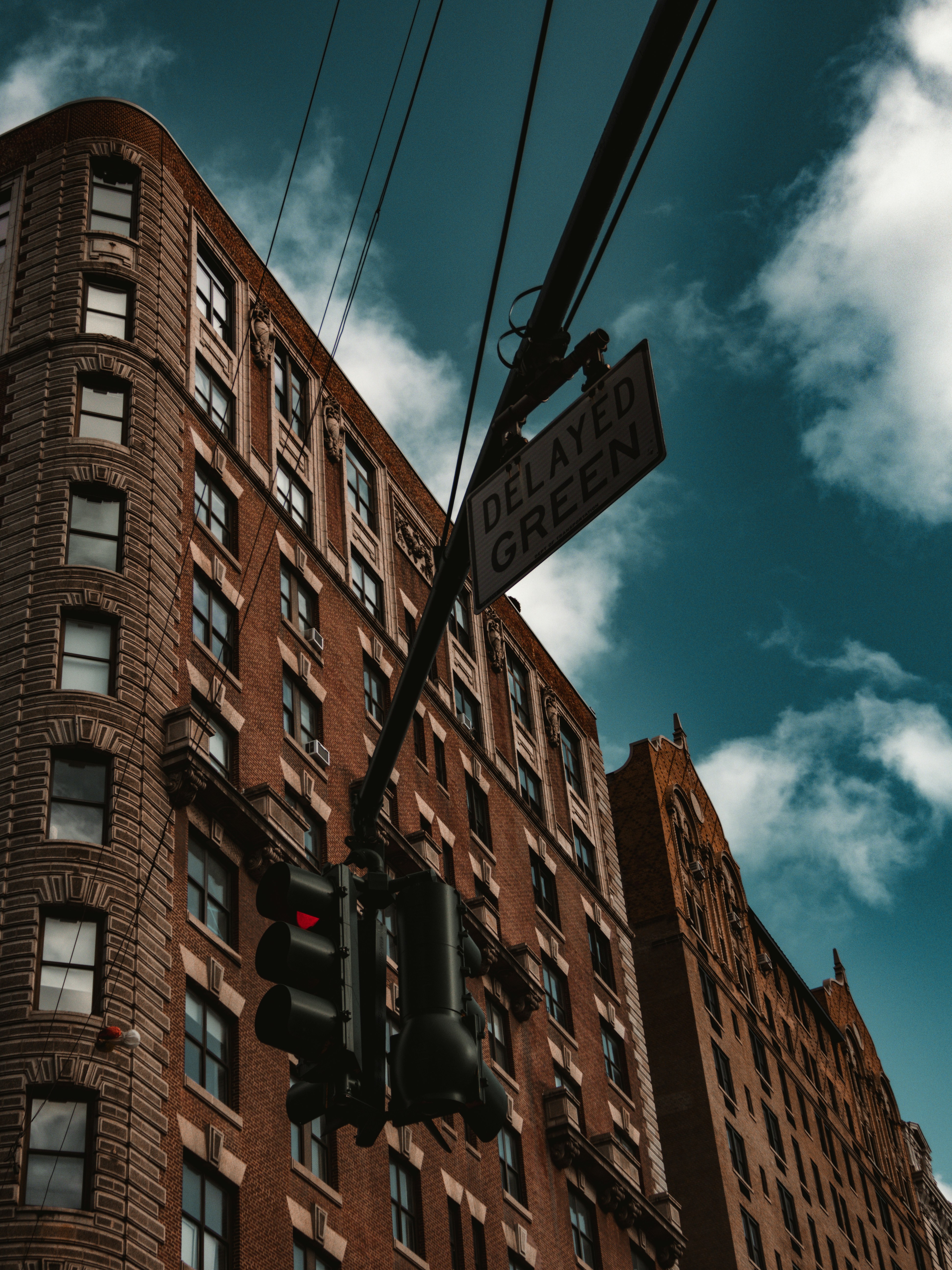 a red traffic light sitting below a tall building