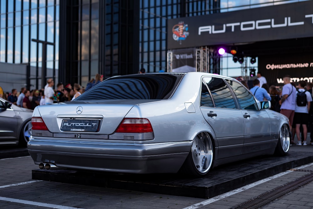 a silver car parked in front of a building