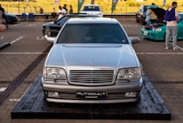 A mechanic inspecting a Mercedes-Benz vehicle in a well-lit garage, showcasing expertise in automotive repairs.