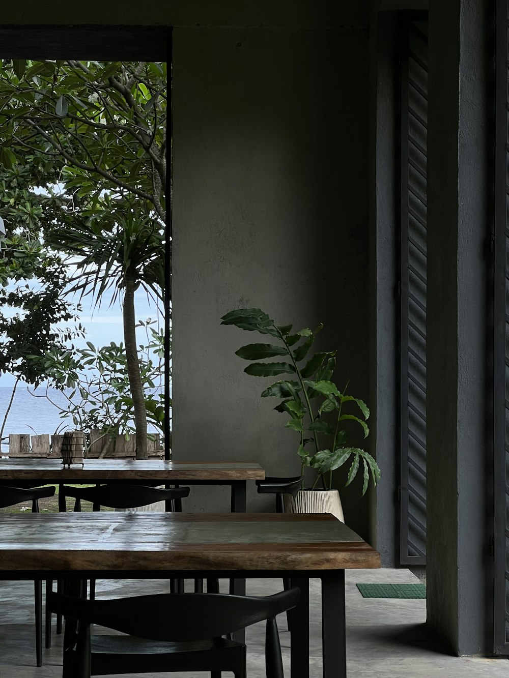 a wooden table sitting in front of a window