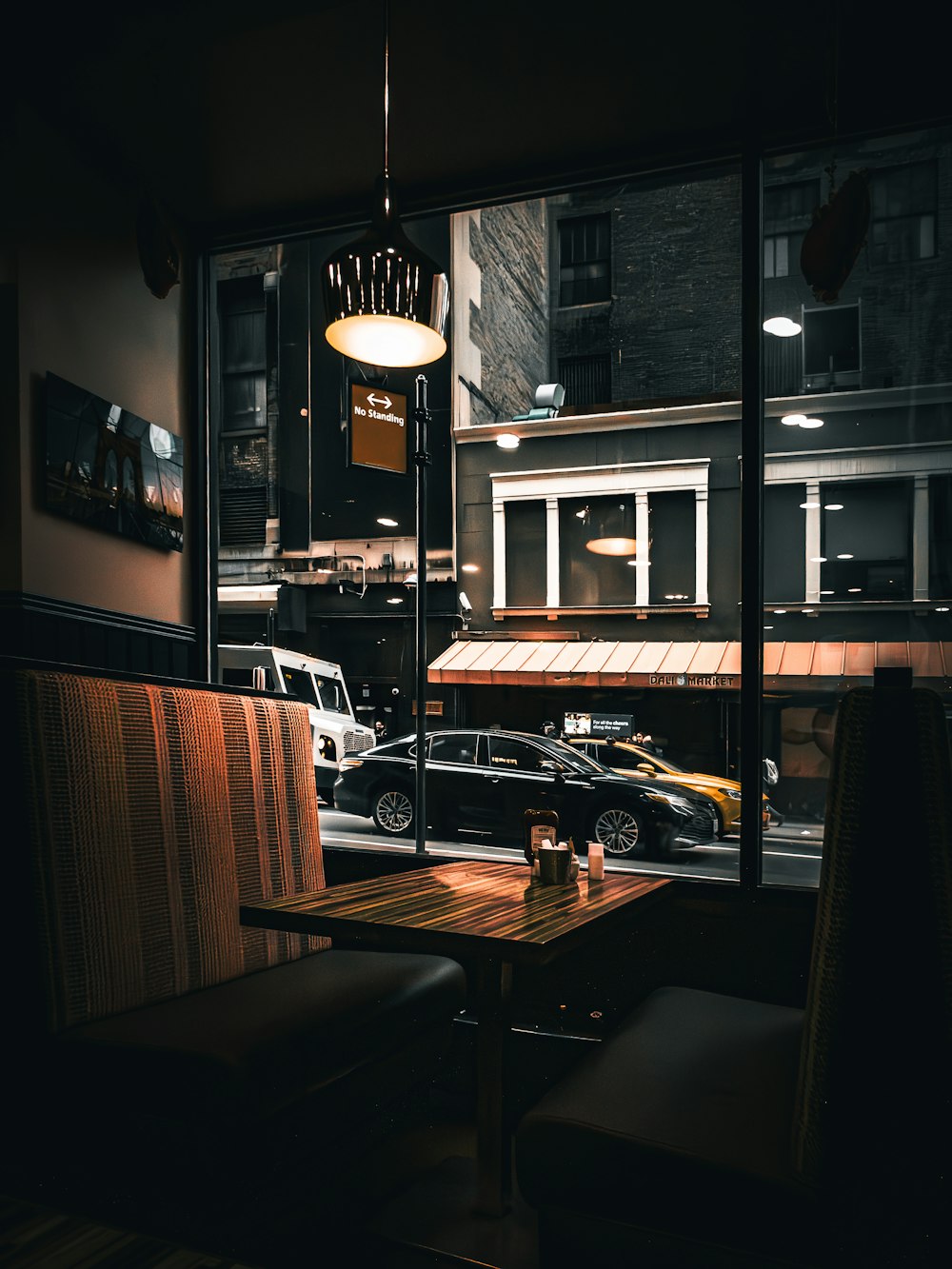 a view of a restaurant through a window at night