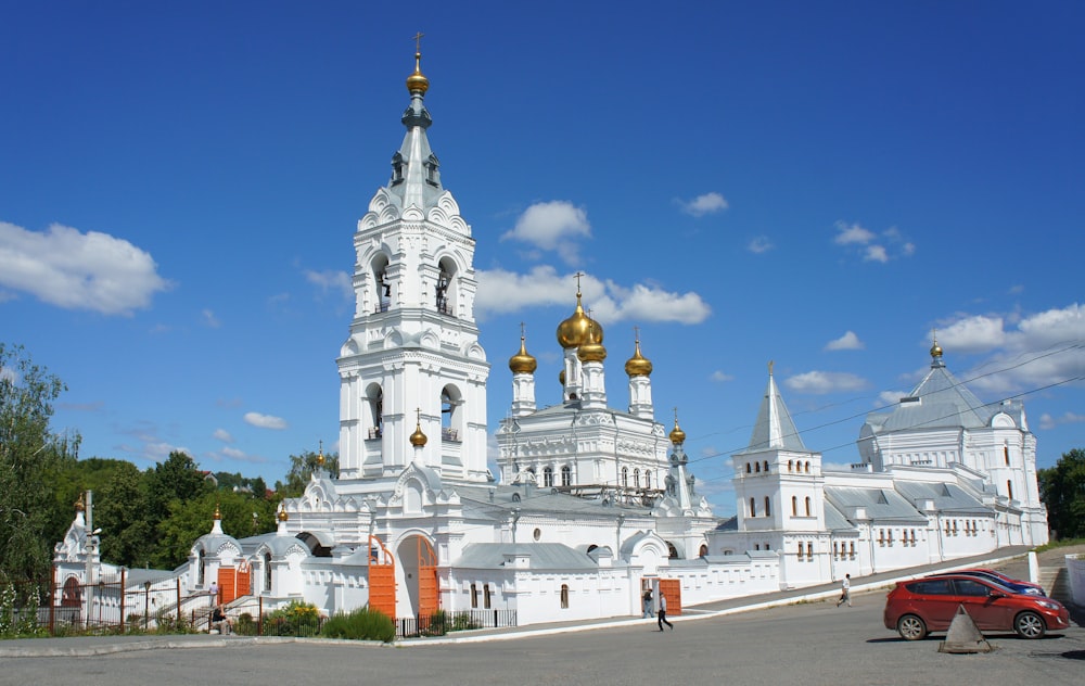 a large white building with gold domes on top of it