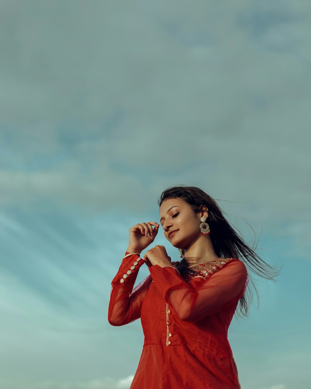 a woman in a red dress holding a cell phone