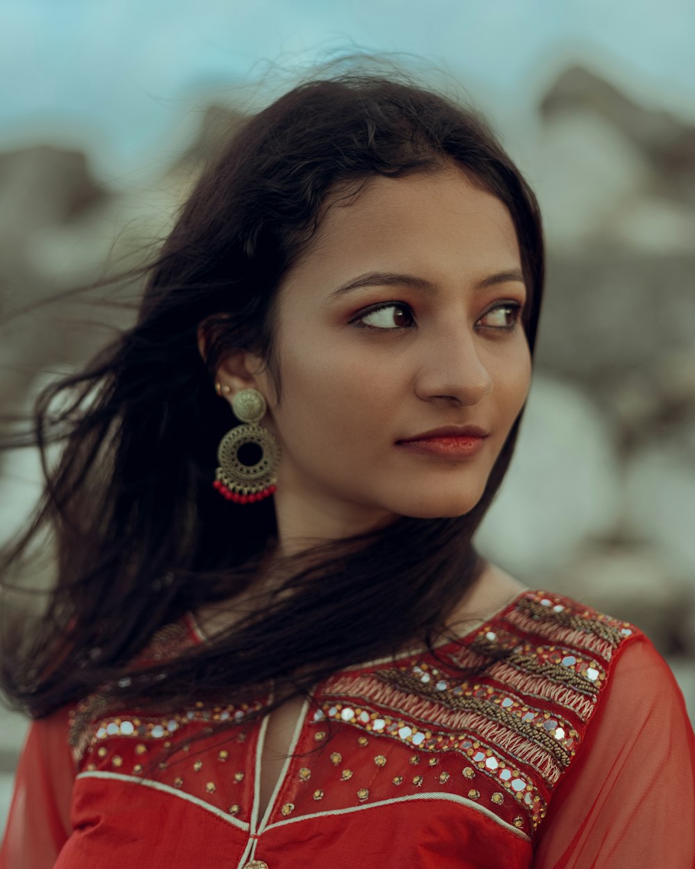 a woman in a red dress with long hair