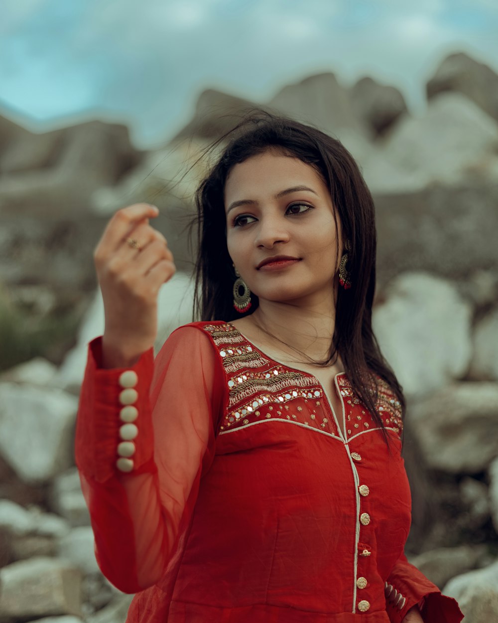 a woman in a red dress is posing for a picture