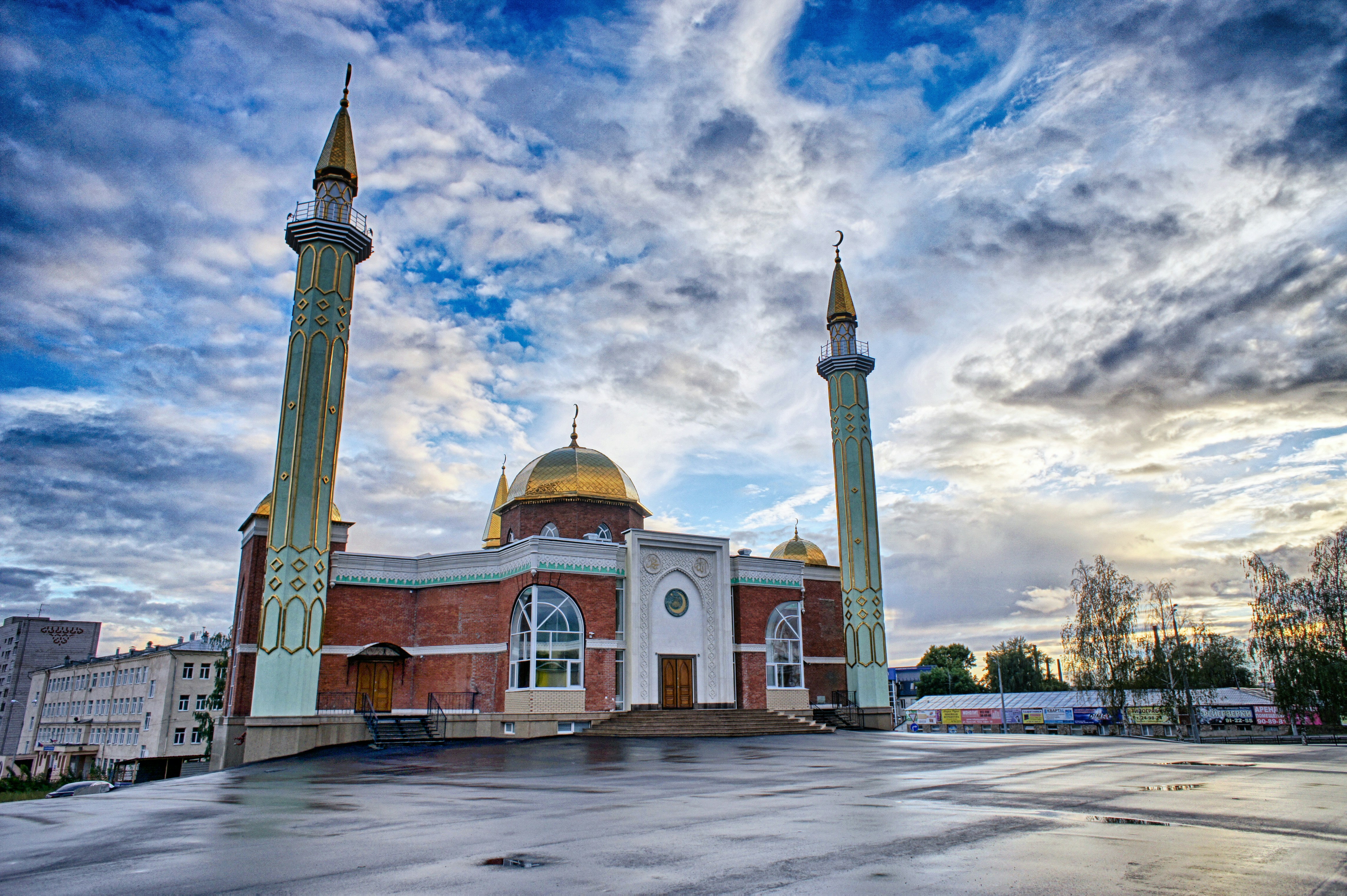 a large building with two tall towers in front of a cloudy sky
