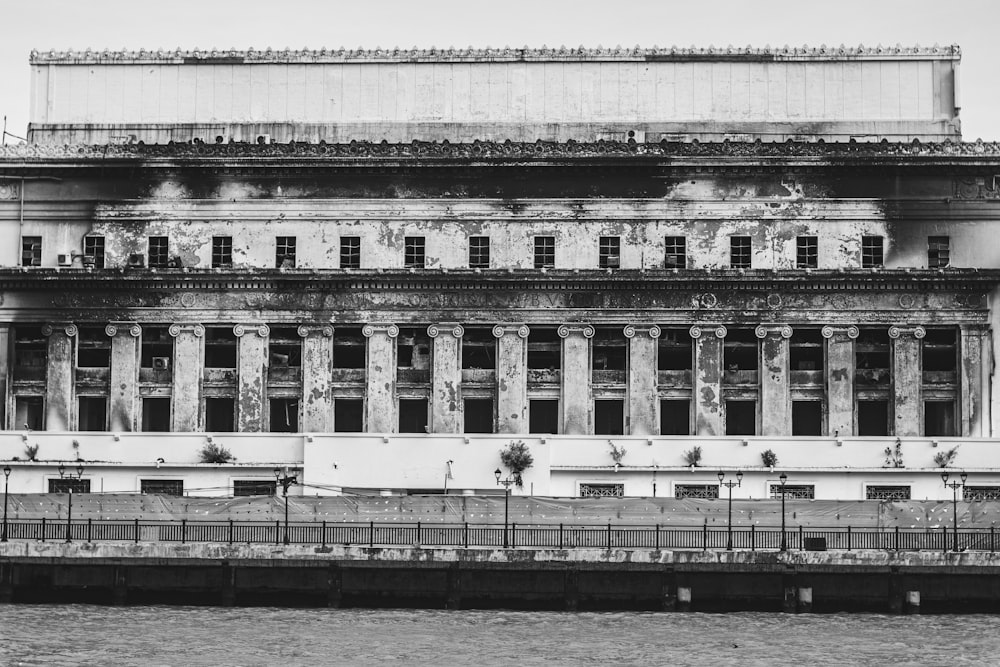 un grande edificio seduto accanto a uno specchio d'acqua