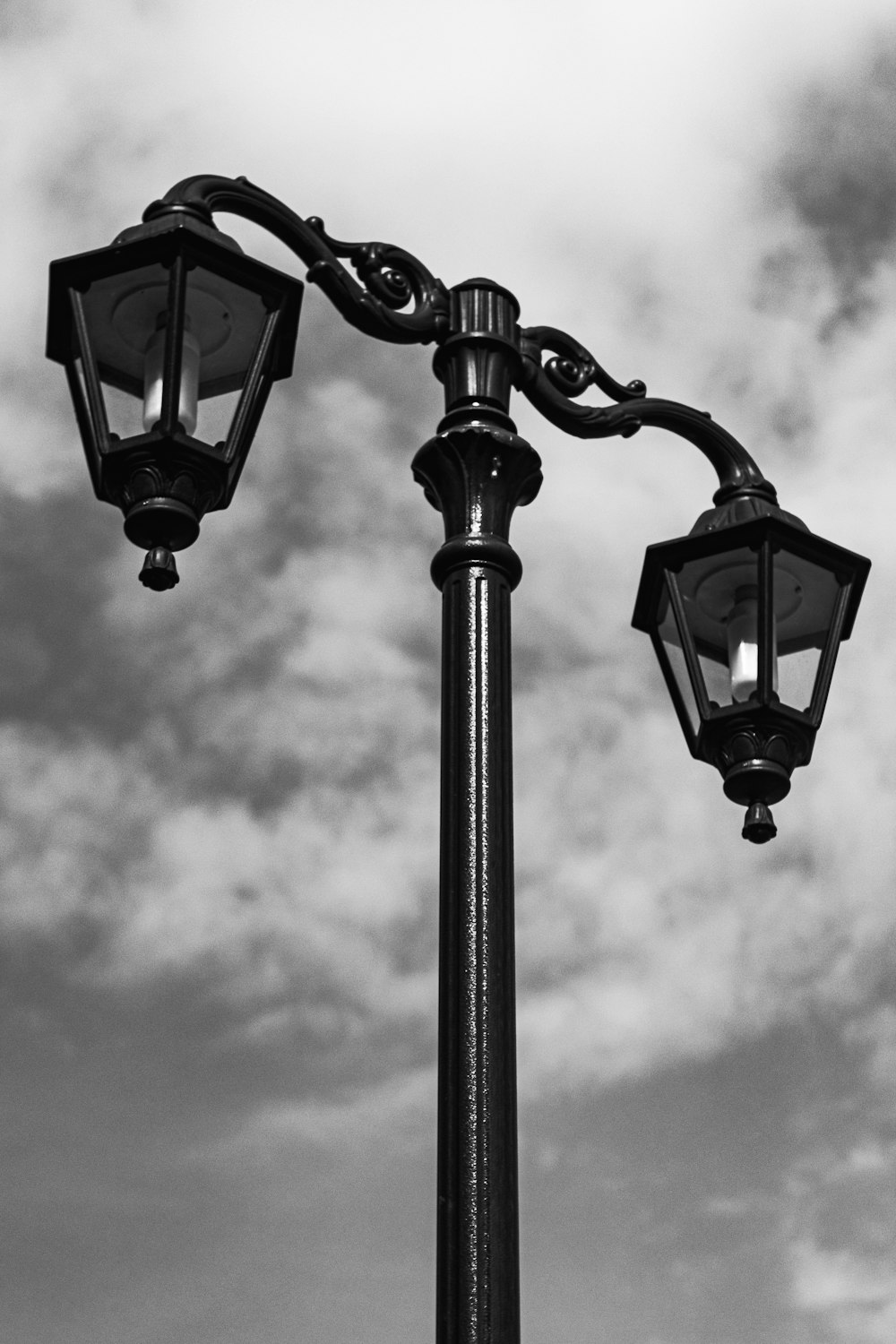 a black and white photo of a street light