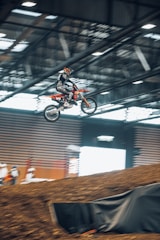 An advanced rider practicing jumps in an arena.