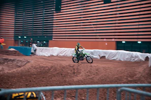 Close-up of a rider adjusting their helmet before a pitbike training session indoors