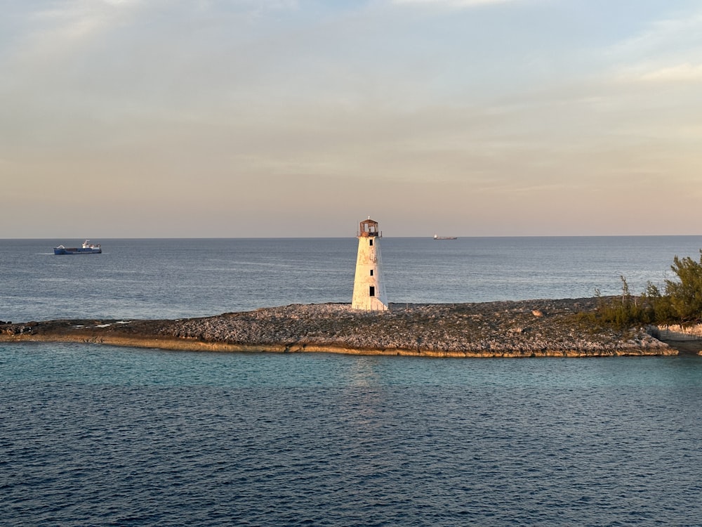 a light house on an island in the middle of the ocean