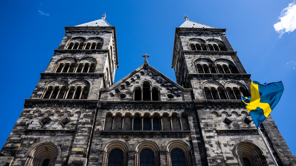 a large cathedral with a flag flying in front of it