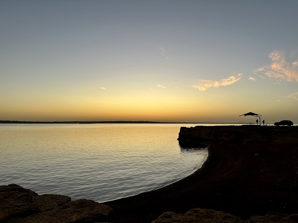 the sun is setting over a body of water