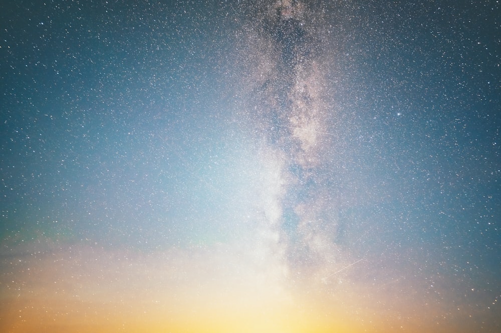 a view of the night sky with the milky in the distance