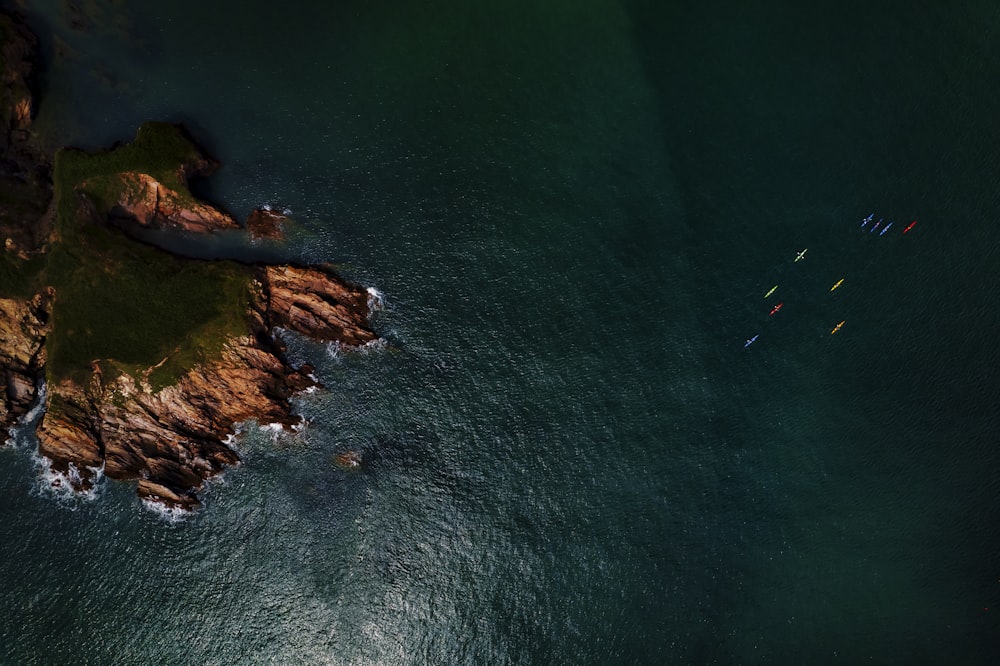 a group of boats floating on top of a body of water