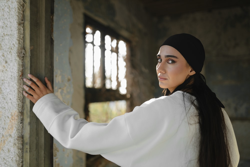 a woman in a white shirt and a black hat