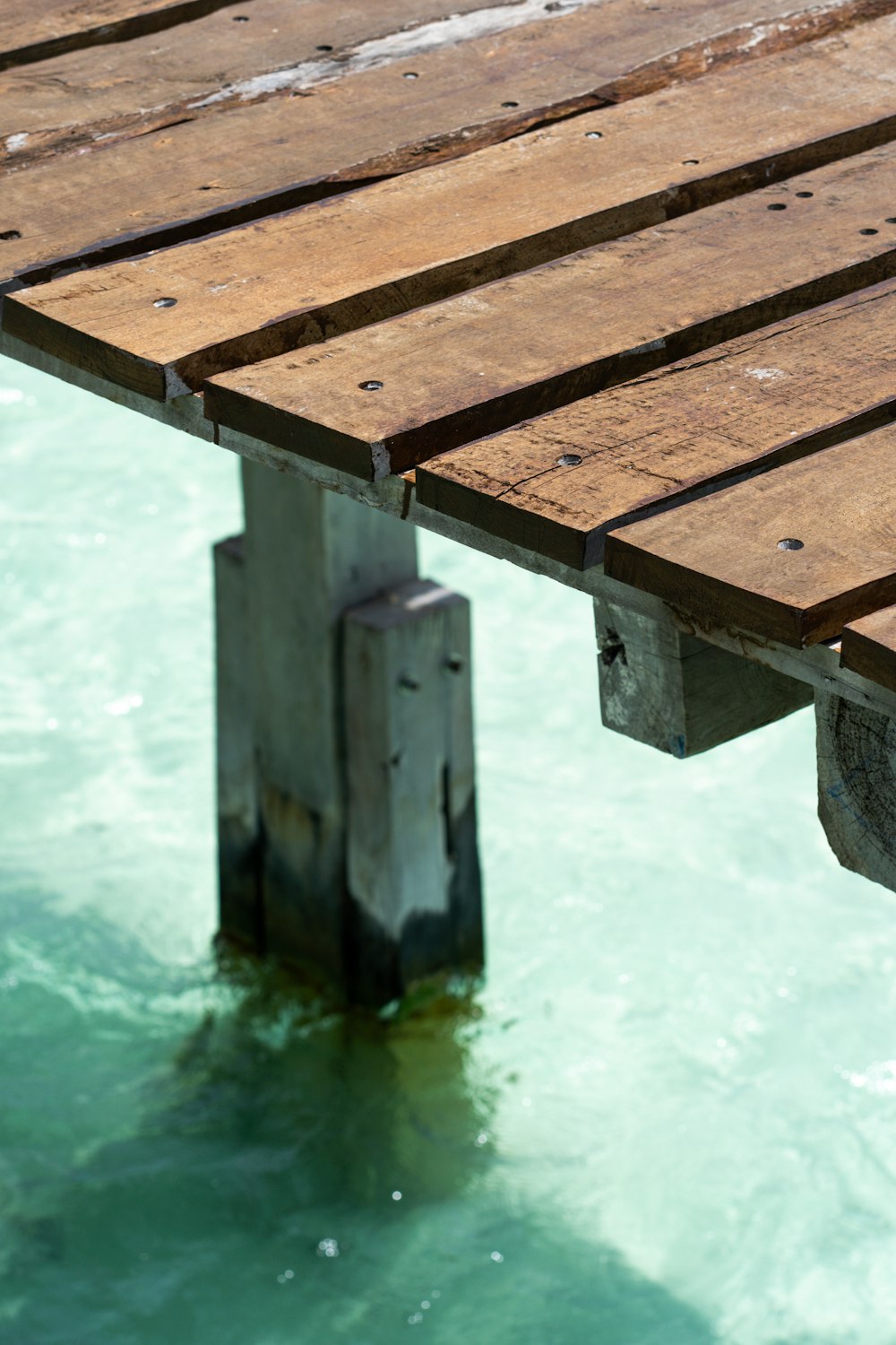 a close up of a wooden dock in the water