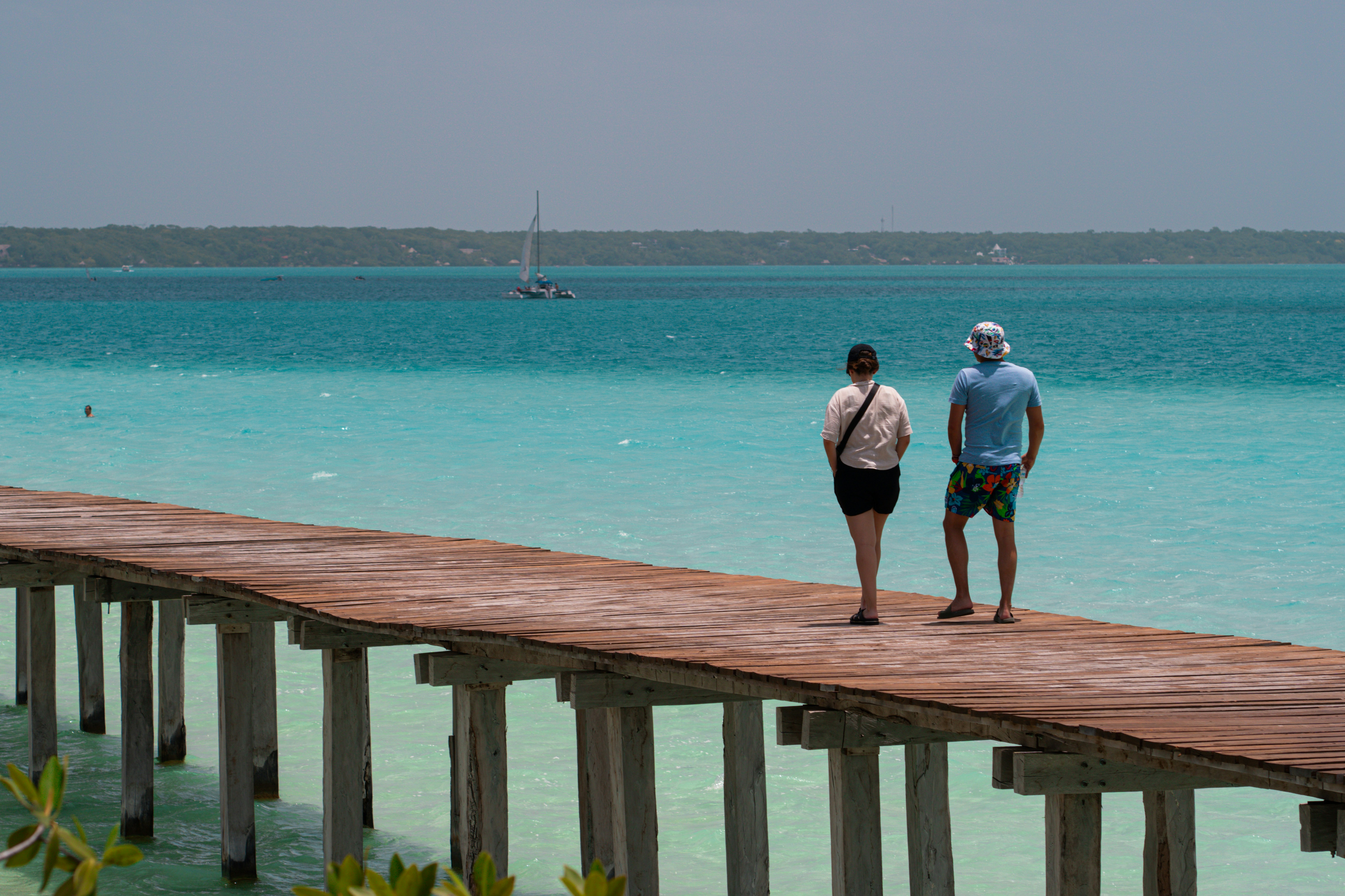 a couple of people that are standing on a dock
