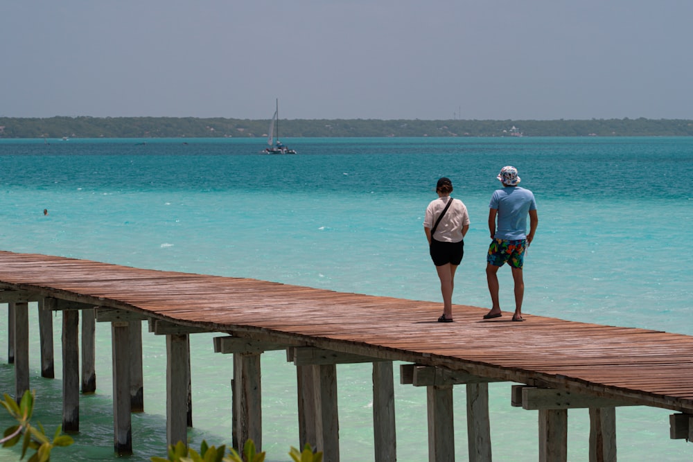 a couple of people that are standing on a dock