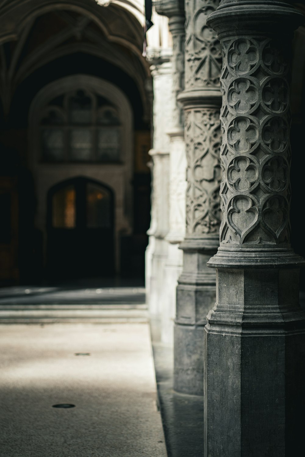 a black and white photo of a clock on a pillar