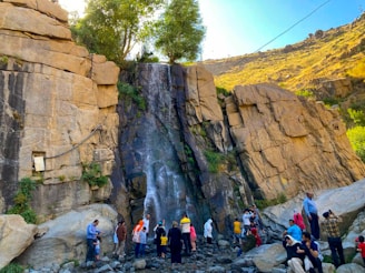 A community gathering around a sustainable water source in a natural setting.