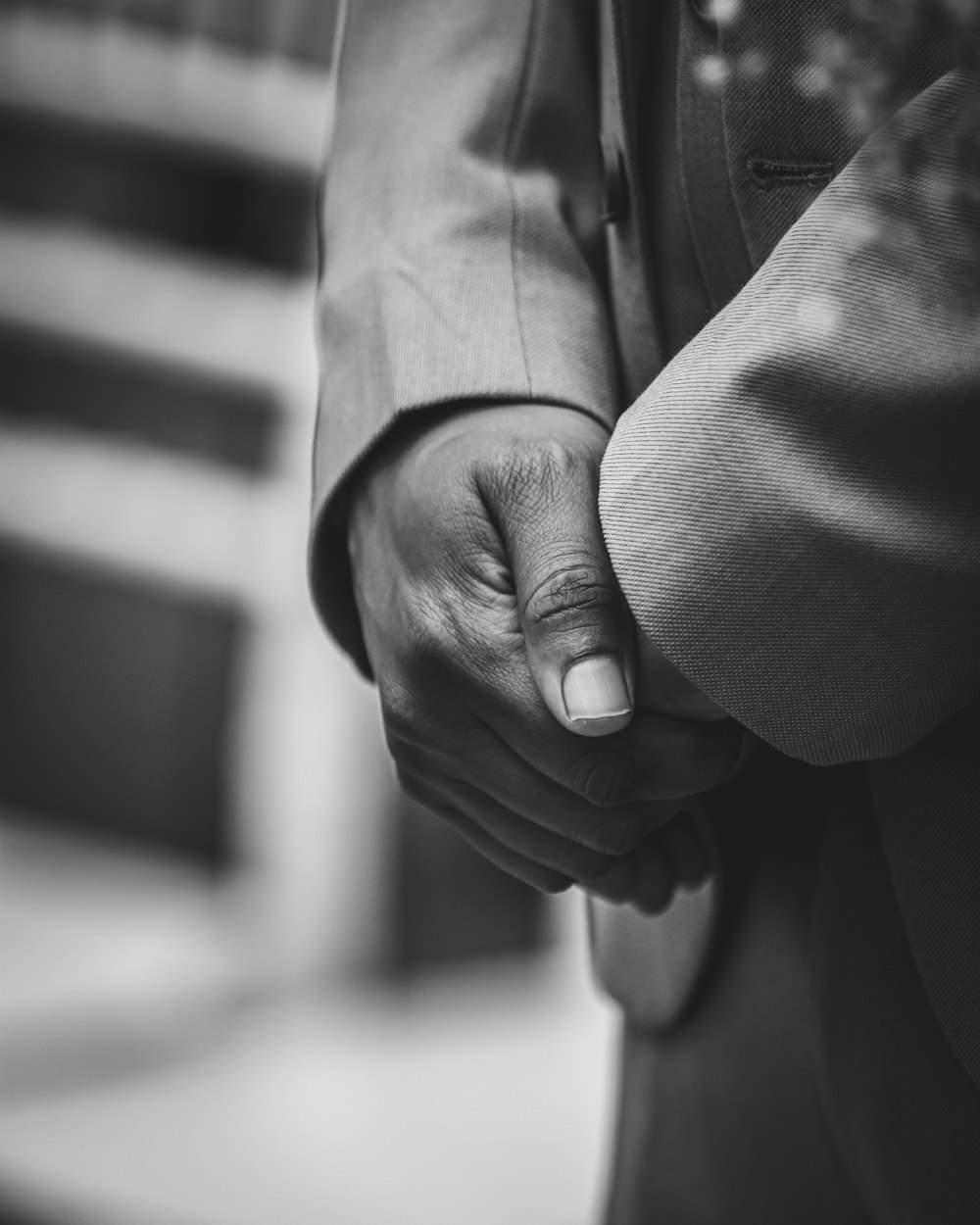 a close up of two people holding hands