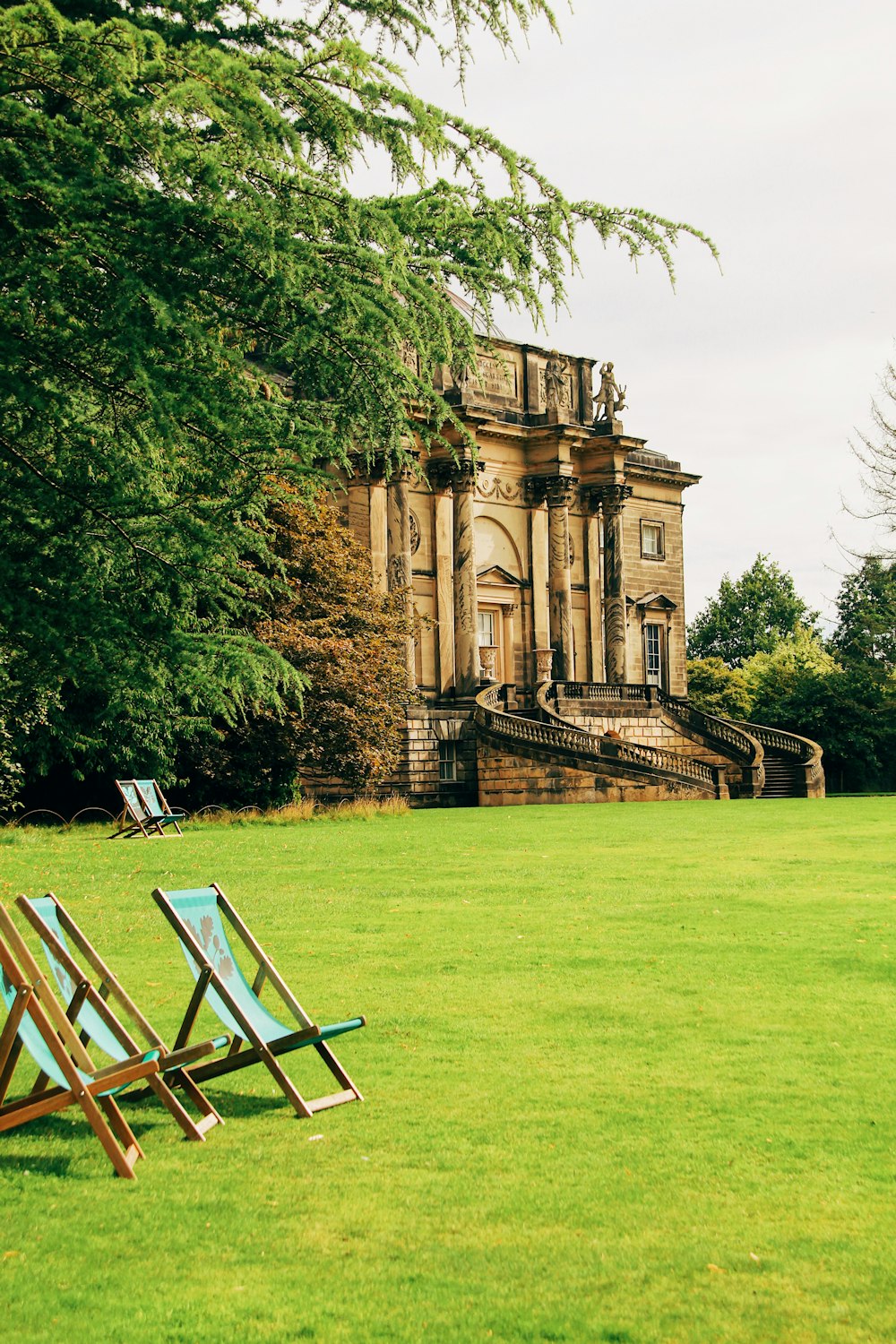 two lawn chairs sitting in front of a building