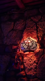 A cozy riad courtyard with traditional Moroccan lanterns glowing warmly at dusk.