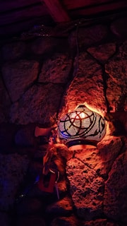 Warm candle-lit corner with intricate lanterns casting delicate shadows on textured walls.