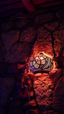 A warm, inviting Moroccan riad courtyard with lanterns glowing at dusk.