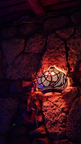 A cozy Moroccan riad courtyard lit by warm lanterns at dusk.