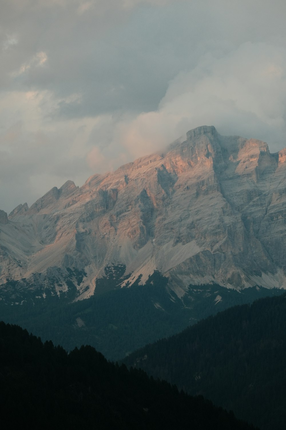 a view of a mountain range with clouds in the sky