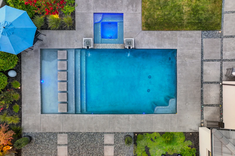 Aerial view of pool surrounded by greenery