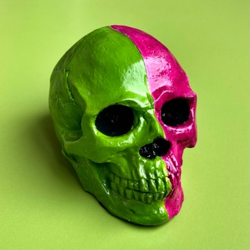 A close-up of a divided face NFT showing a human skull with exposed brain on one side and a glowing alien visage on the other.