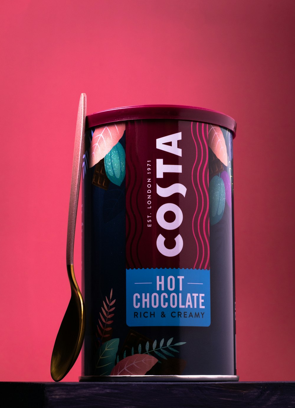 a can of cocoa with a spoon in it