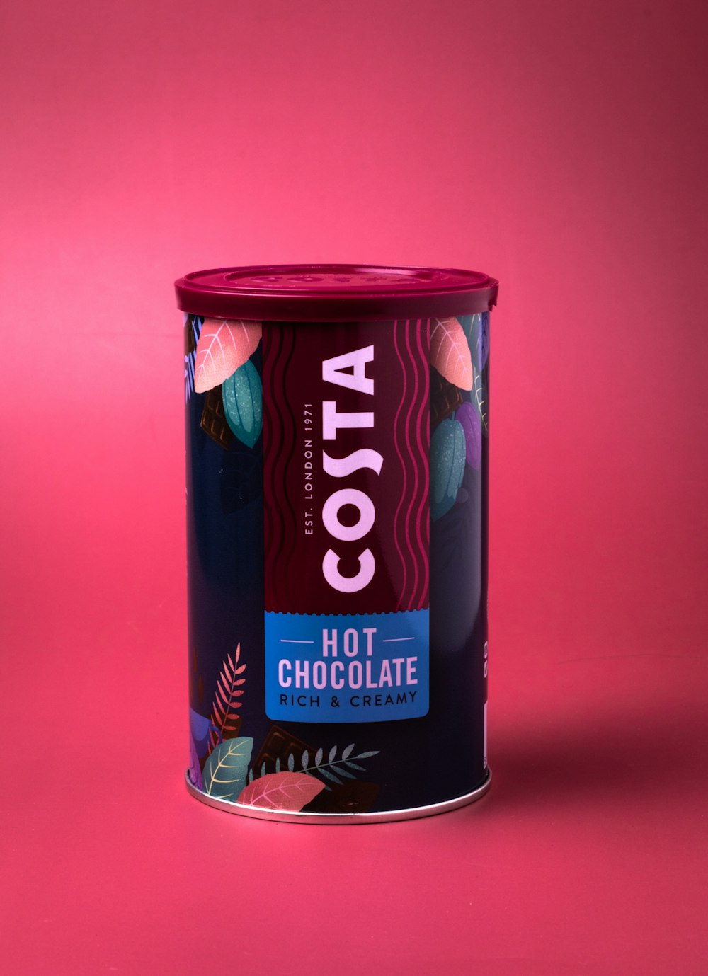 a can of cocoa on a pink background