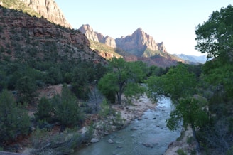 A picturesque view of a river with mountains in the background.