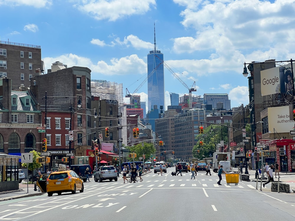 a busy city street with tall buildings in the background