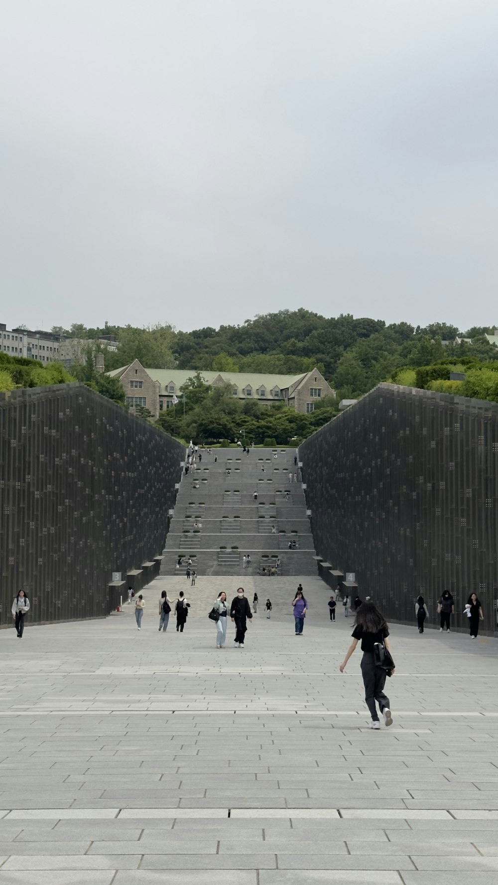 a group of people walking around a stone walkway