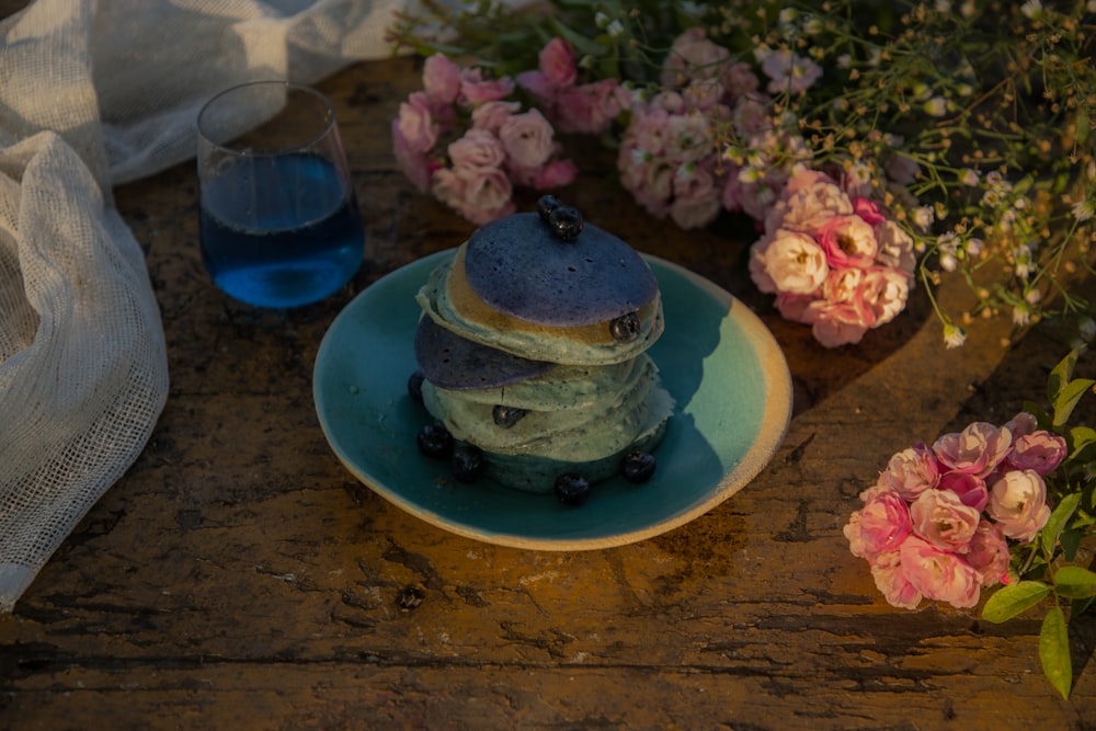 a stack of pancakes sitting on top of a blue plate