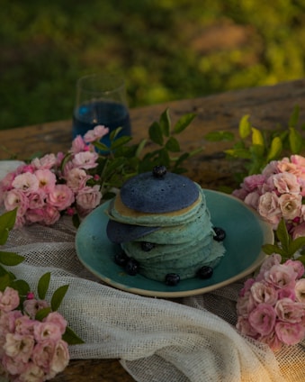 a stack of pancakes sitting on top of a blue plate