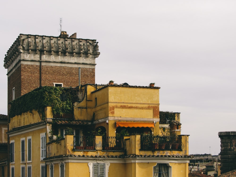 a yellow building with a balcony and balconies